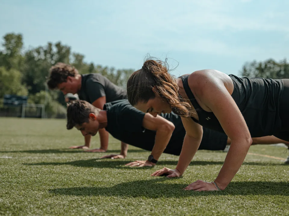 Klomper teammates completing push-ups together